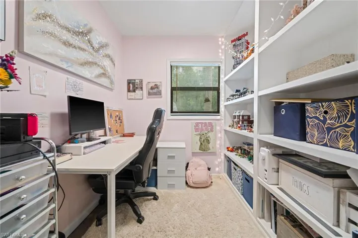 In the the 4th bedroom there is a small Office area with build in shelving. featuring carpet floors