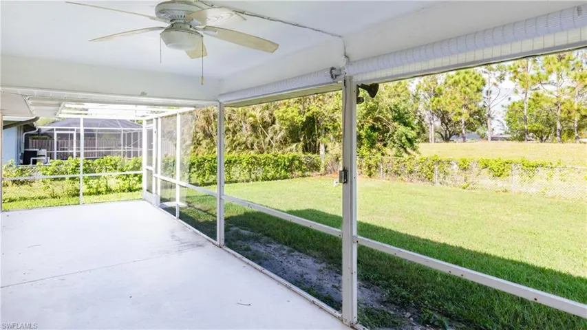 Unfurnished sunroom with ceiling fan