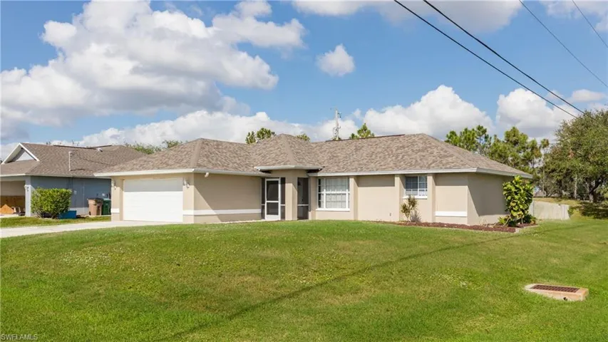 Ranch-style home with a garage and a front yard