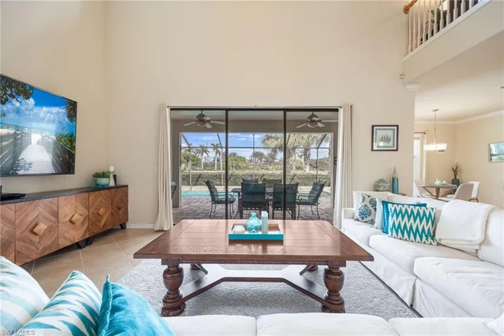 Living room featuring crown molding and light tile patterned flooring