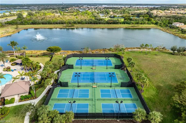 Birds eye view of property with a water view