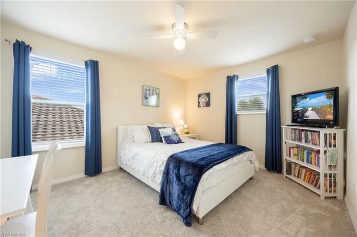 Bedroom featuring ceiling fan and light carpet