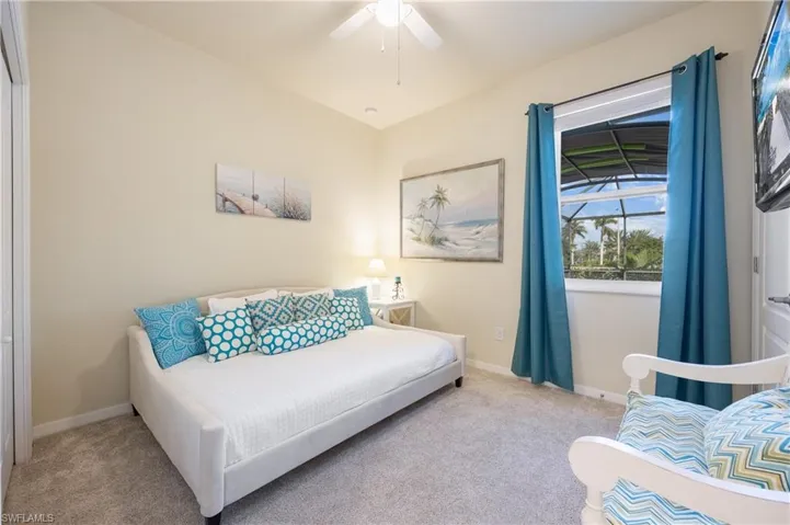 Bedroom featuring light colored carpet and ceiling fan
