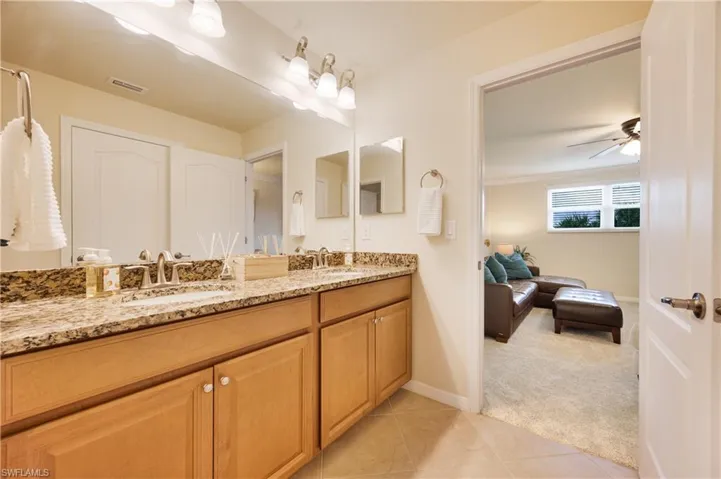 Bathroom featuring vanity, tile patterned floors, ceiling fan, and ornamental molding