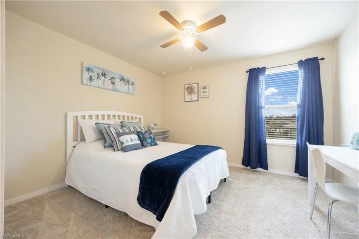 Carpeted bedroom with ceiling fan