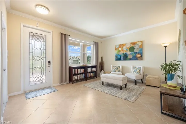 Tiled foyer with crown molding