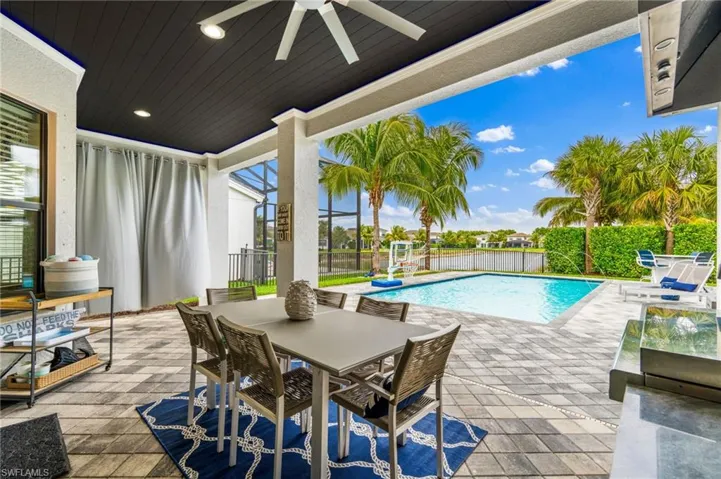 View of pool with a patio and ceiling fan