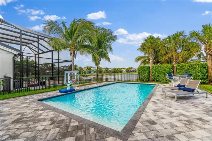 View of pool featuring a lanai, a patio area, and a water view