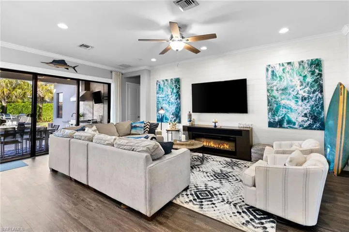 View of patio with a community pool and ceiling fan