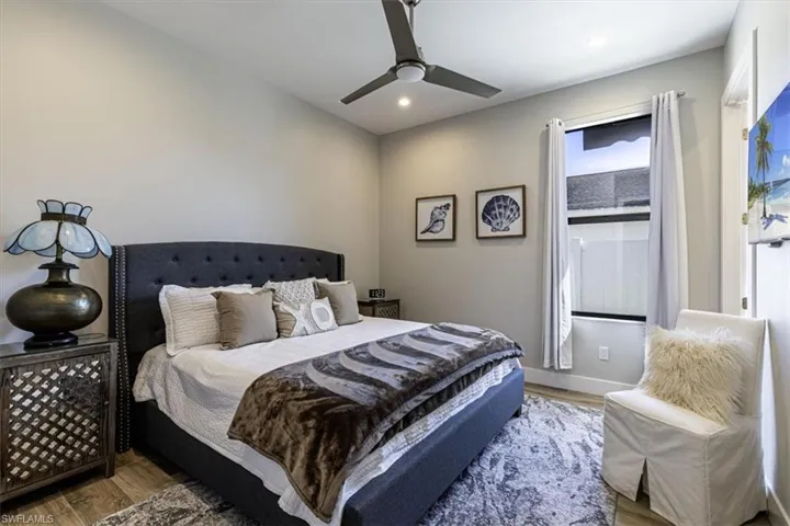 Bedroom featuring wood finished floors, a ceiling fan, and recessed lighting