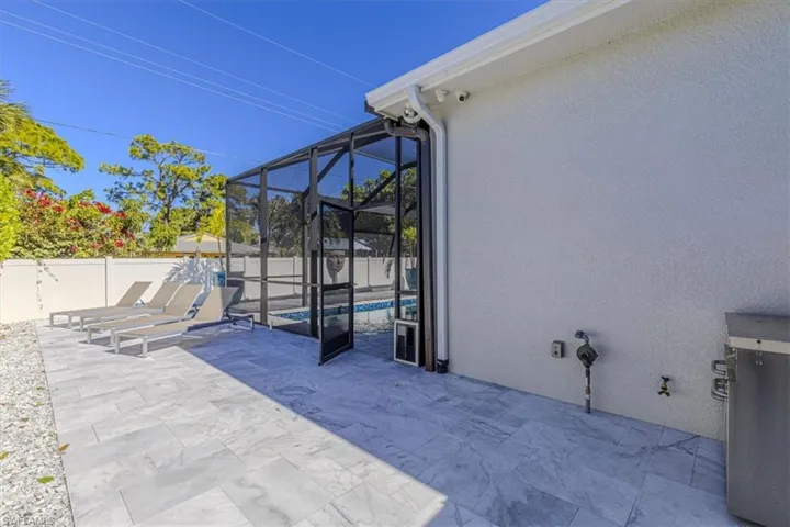 Fenced backyard with a lanai, a patio area, and a sunroom