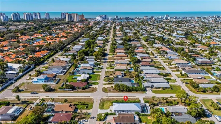 Aerial view of property's location featuring nearby suburban area and a nearby body of water