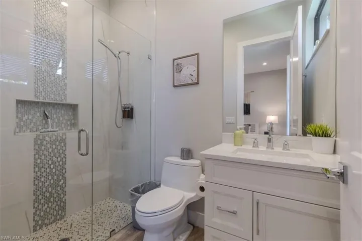 Full bath featuring vanity and a shower stall