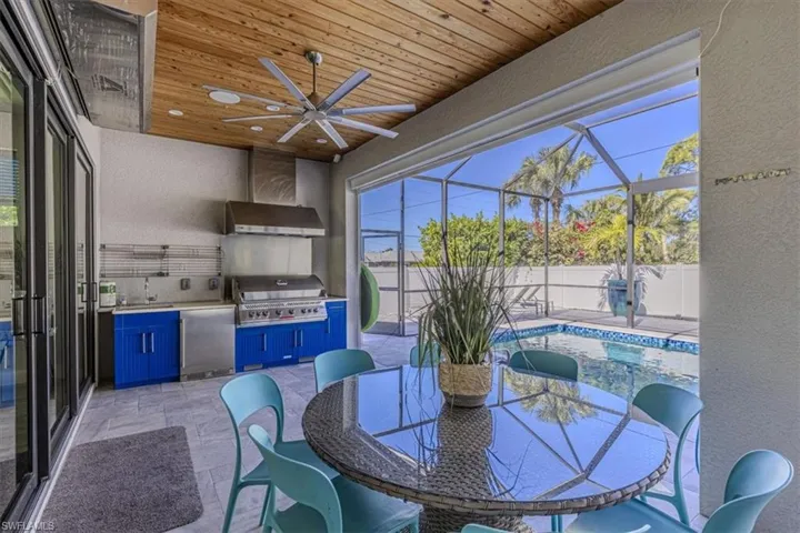 Fenced backyard featuring area for grilling, ceiling fan, a lanai, a patio area, and a sunroom