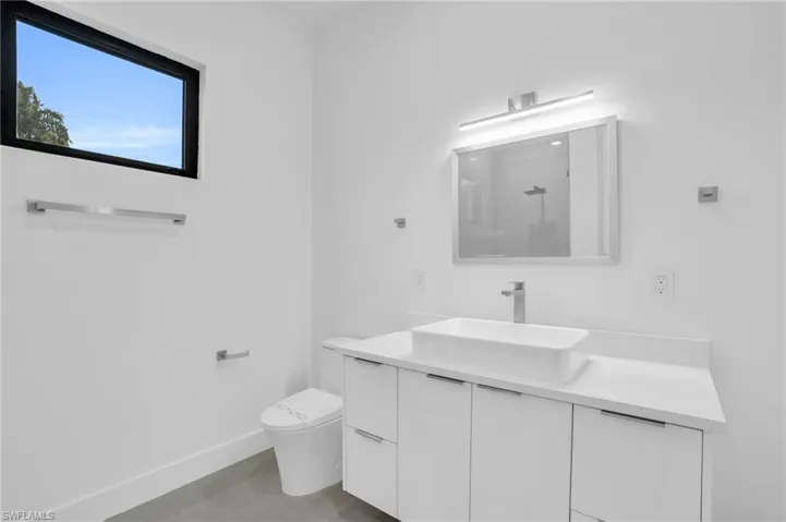 Bathroom with large vanity and toilet
