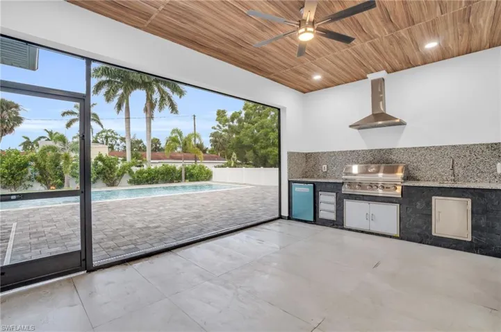 Kitchen featuring wooden ceiling, extractor fan, ceiling fan, and tasteful backsplash