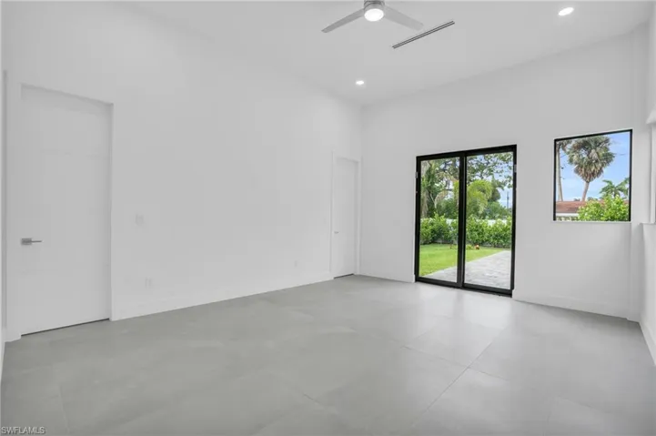 Tiled spare room with ceiling fan