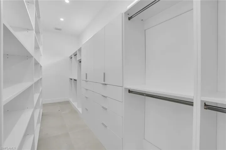 Spacious closet with light tile floors