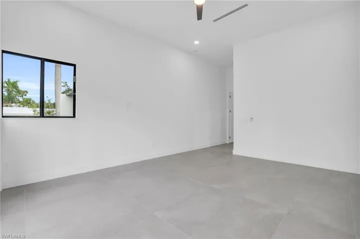 Empty room with tile flooring and ceiling fan