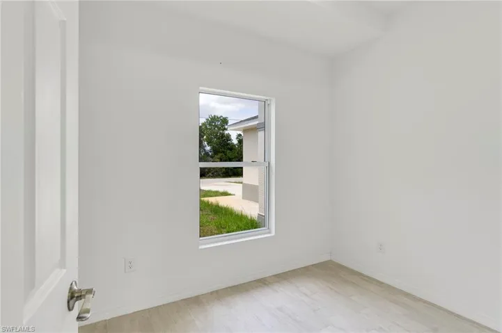 Unfurnished room with plenty of natural light and light wood-type flooring