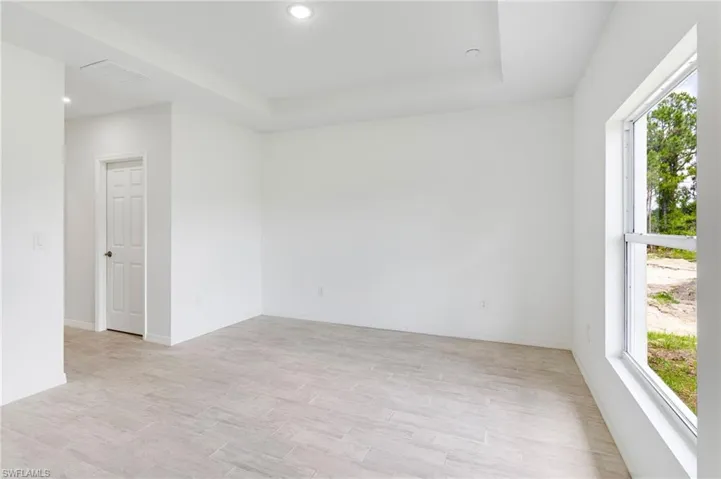 Spare room featuring a tray ceiling