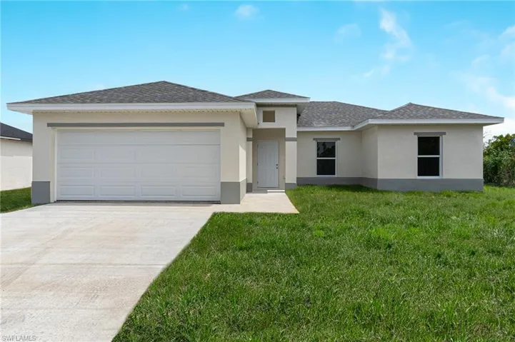 Prairie-style house featuring a garage and a front yard