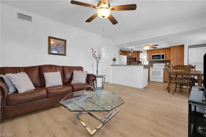 Living area featuring light wood-style floors and a ceiling fan