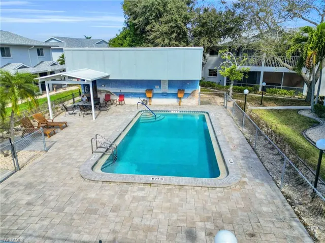 Community pool with a patio