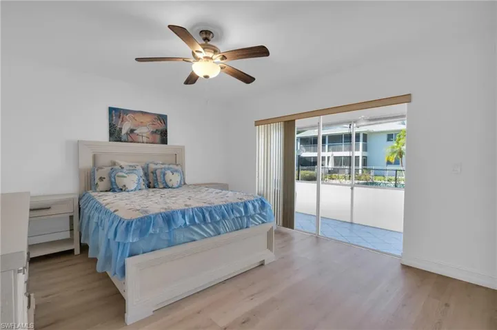 Bedroom with light wood-style floors and a ceiling fan