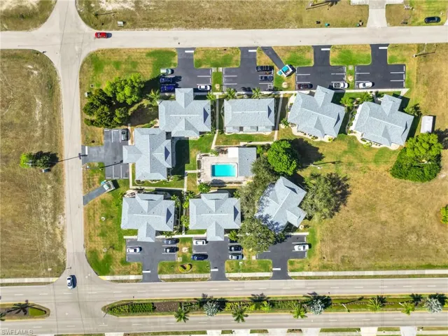 Aerial view of property and surrounding area with nearby suburban area