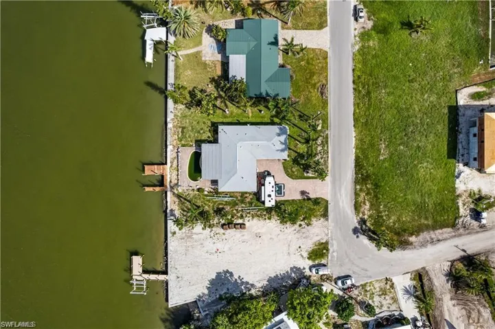 Birds eye view of property with a water view