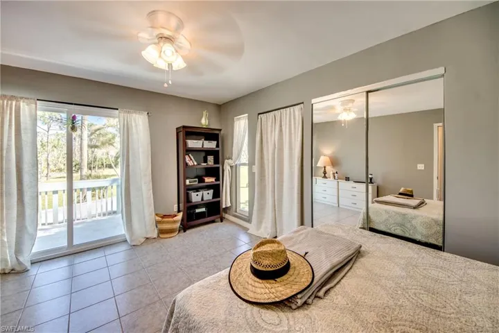Living area with ceiling fan and light tile patterned flooring