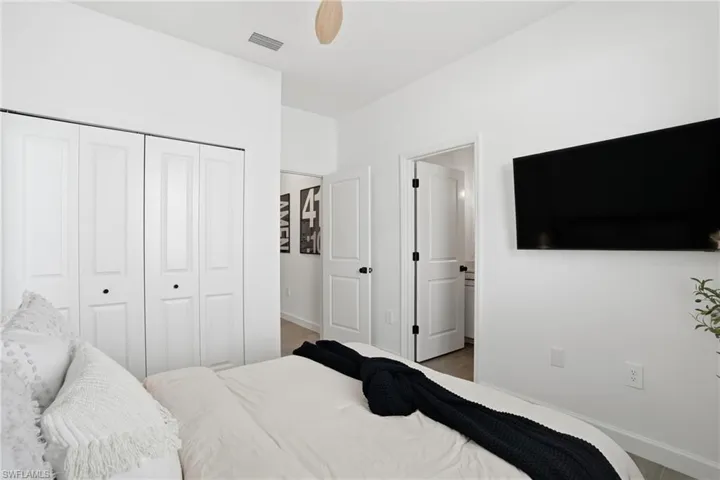 Bedroom with a closet, a ceiling fan, and wood finished floors