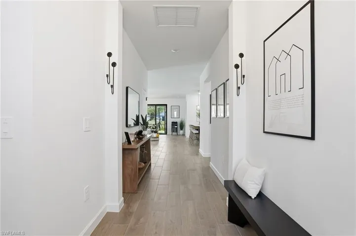 Corridor with light wood-style floors and baseboards