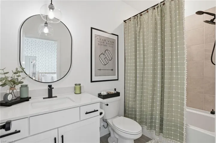 Bathroom with vanity and shower / tub combo