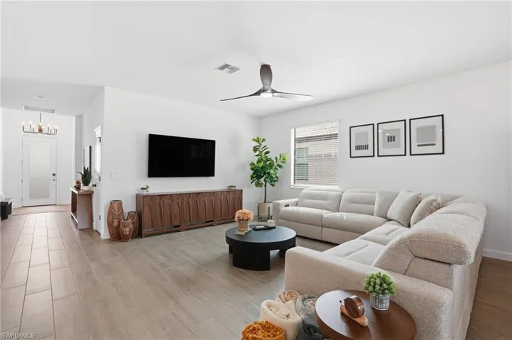 Living area with wood finished floors and ceiling fan