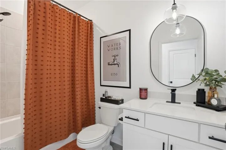 Full bathroom with shower / bathtub combination with curtain and vanity