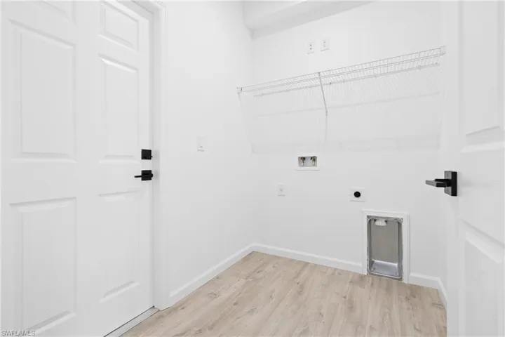 Washroom featuring light wood-style flooring, washer hookup, and electric dryer hookup