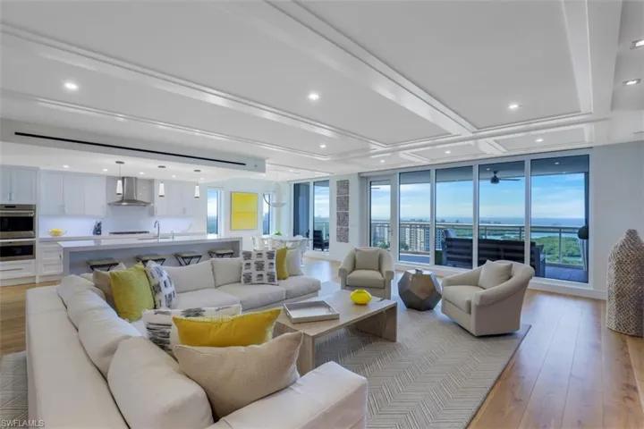 Living room featuring light wood finished floors, healthy amount of natural light, and recessed lighting