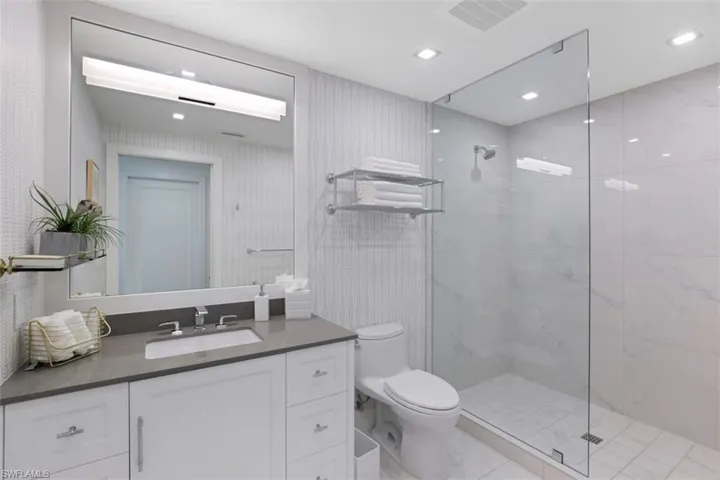 Full bath with vanity, walk in shower, and recessed lighting