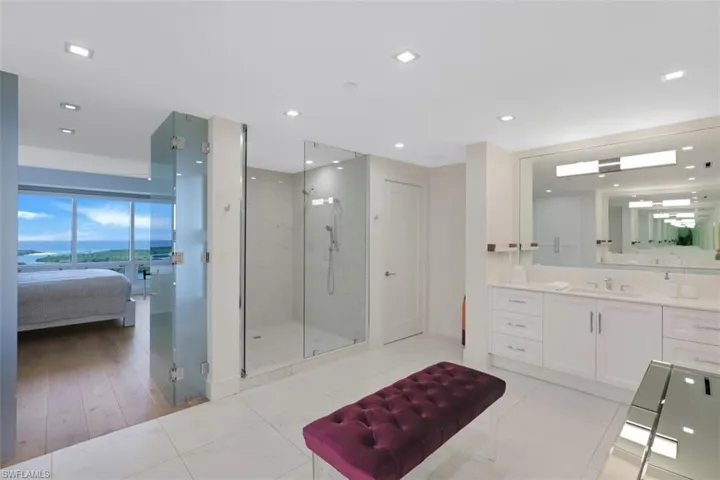 Ensuite bathroom featuring a stall shower, vanity, and recessed lighting
