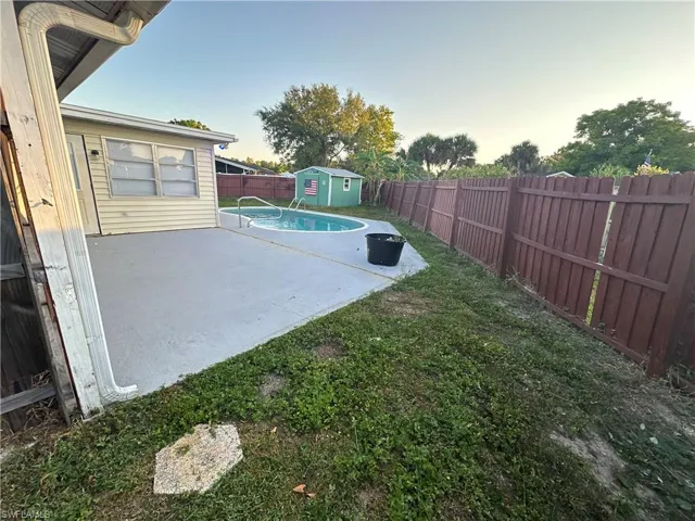View of yard with a fenced in pool and a patio