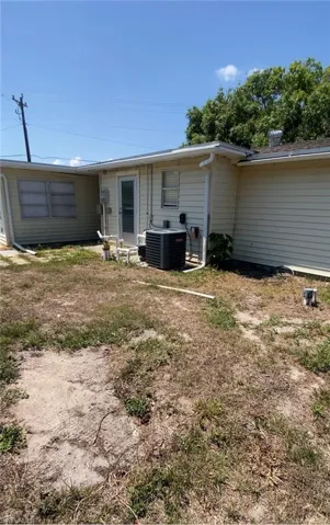 Back of property featuring central air condition unit