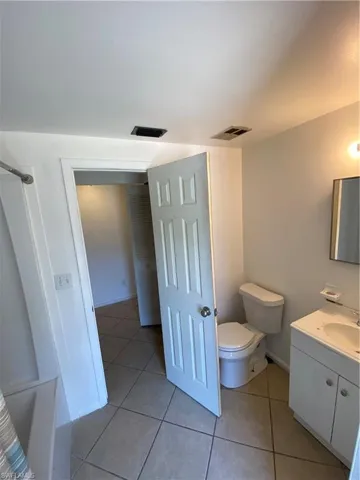 Bathroom featuring tile flooring, toilet, and vanity