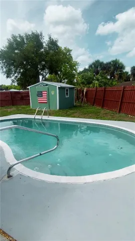 View of pool featuring an outdoor structure