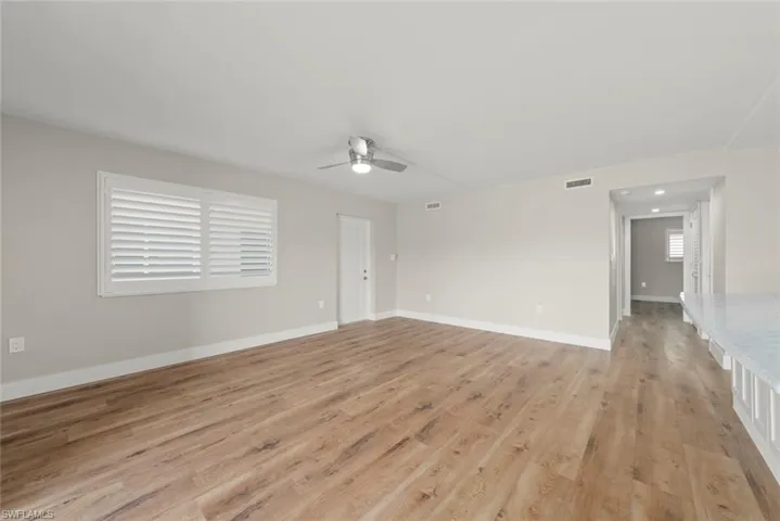 Spare room with light wood-type flooring and ceiling fan