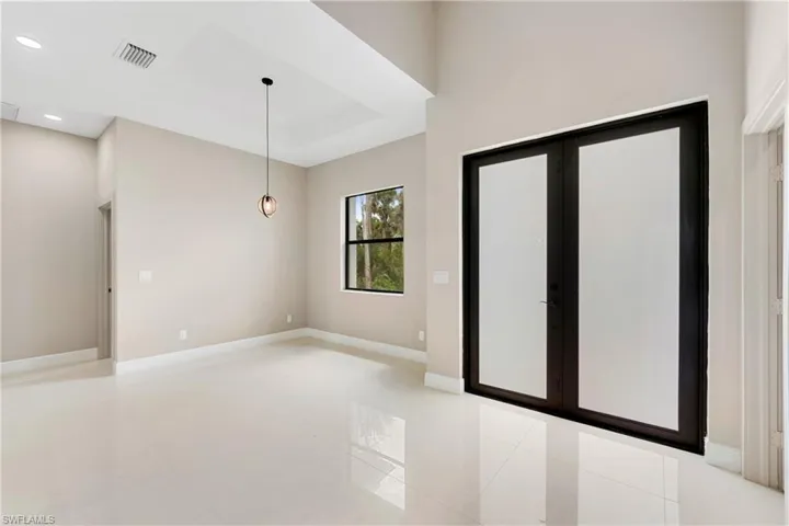 Empty room featuring recessed lighting and french doors
