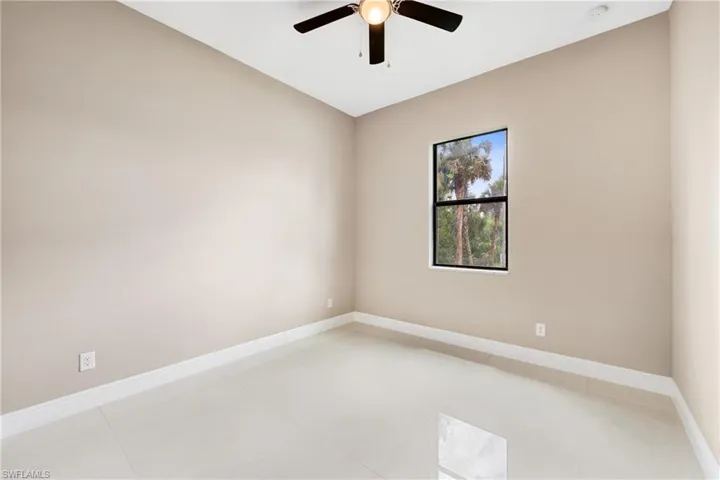 Spare room with baseboards and ceiling fan