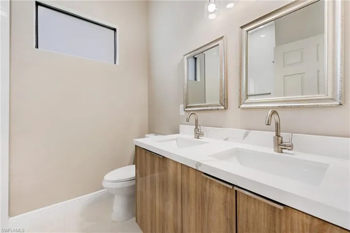 Bathroom with double vanity and toilet