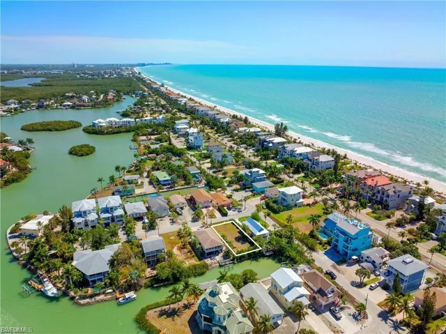 Aerial perspective of suburban area featuring expansive coastline